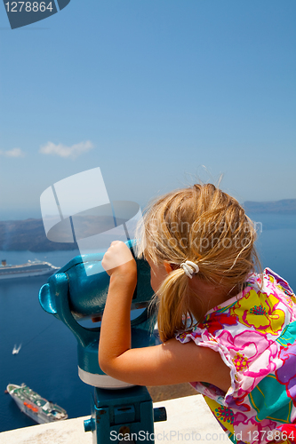 Image of Girl looking with binoculars in Thira, Santorini, Greece