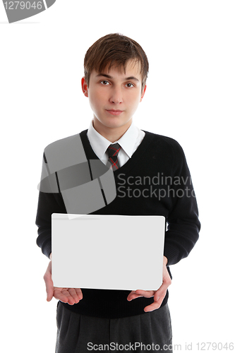 Image of Teen boy holding sign, book or other object