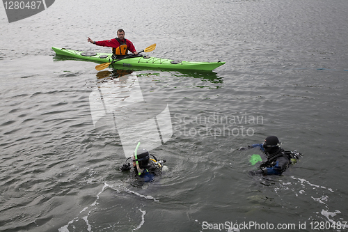 Image of Divers and kayak