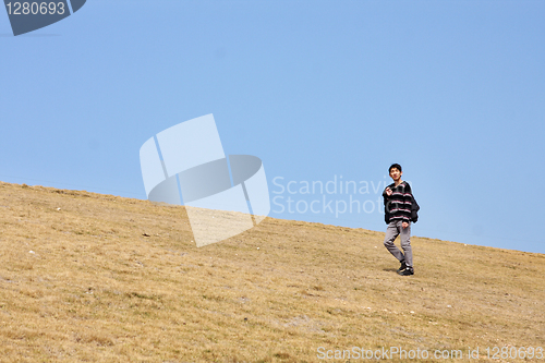 Image of man walking on the mountain