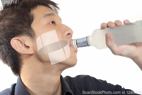 Image of asia man takes drink