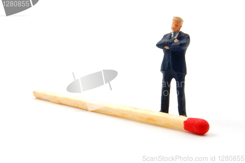 Image of business man and matches on white