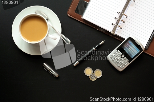 Image of coffee pen phone and paper