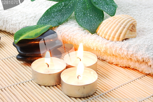 Image of foldet white bath towel and zen stones