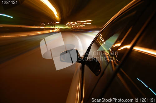 Image of night drive with car in motion 
