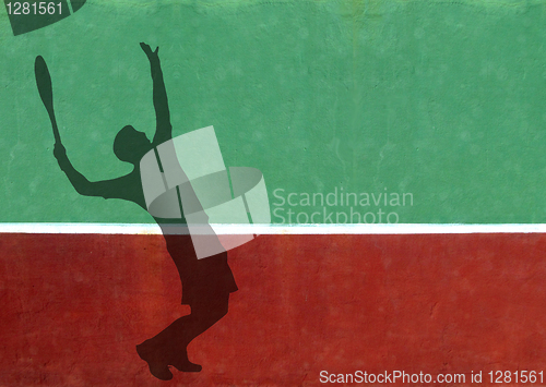 Image of Tennis Player Serving Silhouette Against Practice Wall