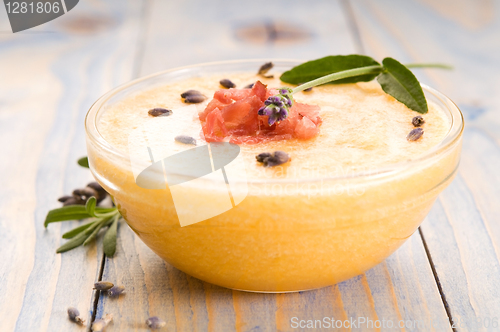 Image of fresh melon soup with parma ham and lavender flower