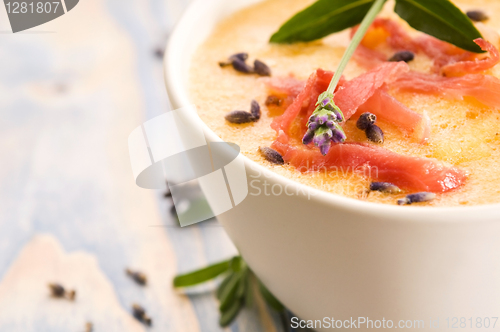 Image of fresh melon soup with parma ham and lavender flower