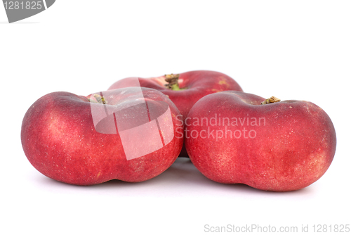 Image of Three red flat peaches