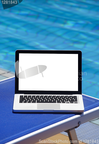 Image of 	Laptop by swimming pool 