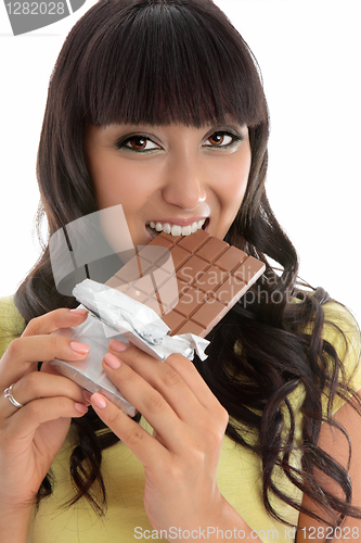Image of Beautiful girl eating decadent chocolate bar