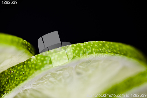 Image of Slices of lime fruit on black