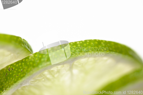 Image of Slices of lime fruit on white