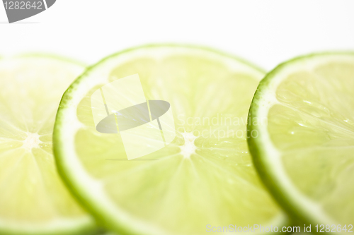 Image of Slices of lime fruit on white