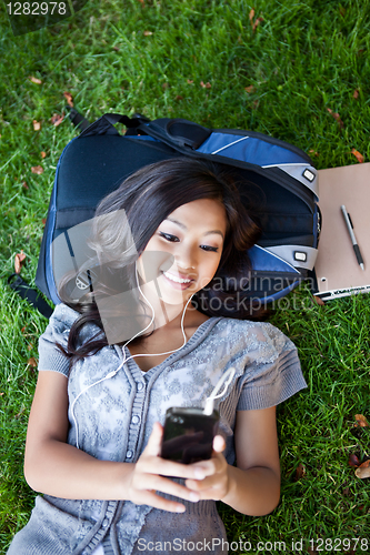 Image of Asian college student listening to music