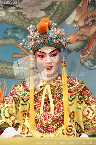 Image of chinese opera dummy and red cloth as text space ,it is a toy,not