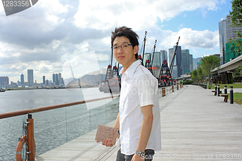 Image of asia man relax in the park in the city 