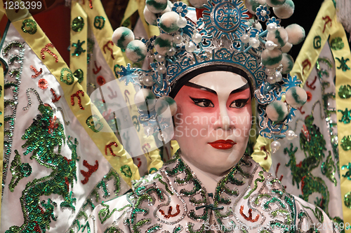 Image of chinese opera dummy and red cloth as text space ,it is a toy,not