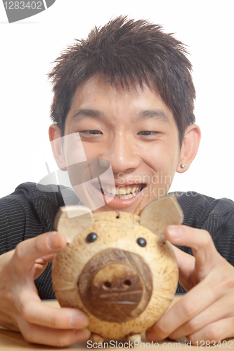 Image of asia man with piggy bank 