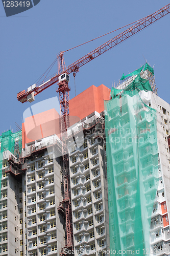 Image of Construction crane at the construction site, on a cloudless sky 