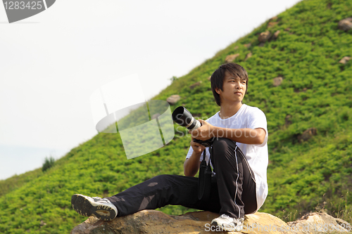 Image of asian man taking photo 