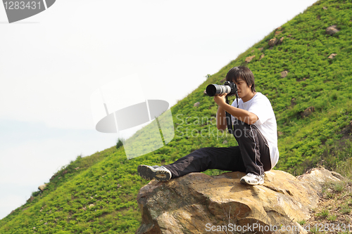 Image of asian man taking photo 