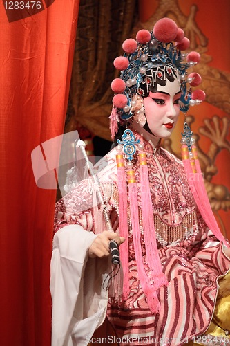 Image of chinese opera dummy and red cloth as text space ,it is a toy,not