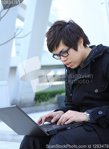 Image of asian man using notebook