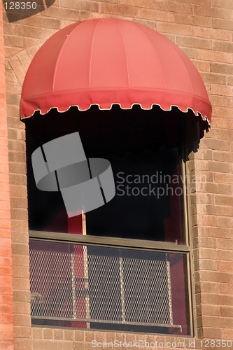 Image of Brick Wall and A Window with Red Awning