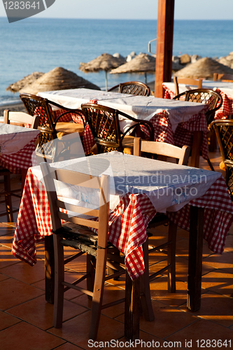 Image of Outdoor restaurant tables in Perissa, Santorini, Greece