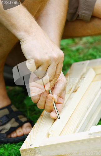 Image of Man's hands on a screwdriver