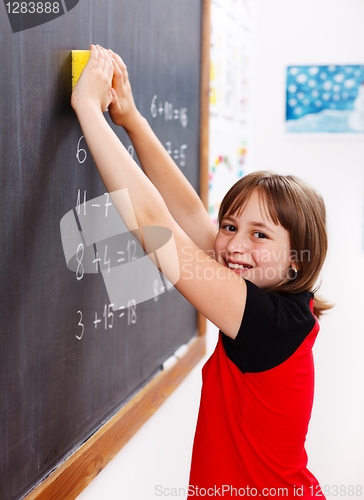 Image of Elementary school student erasing chalkboard