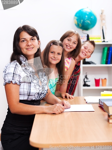 Image of Cheerful teacher and several students