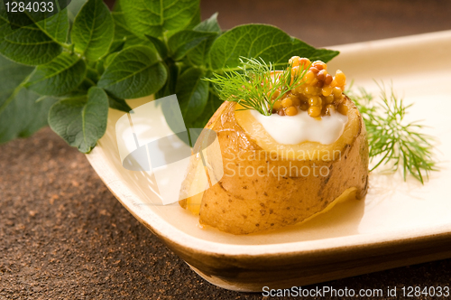 Image of Baked potato with sour cream, grain Dijon mustard and herbs