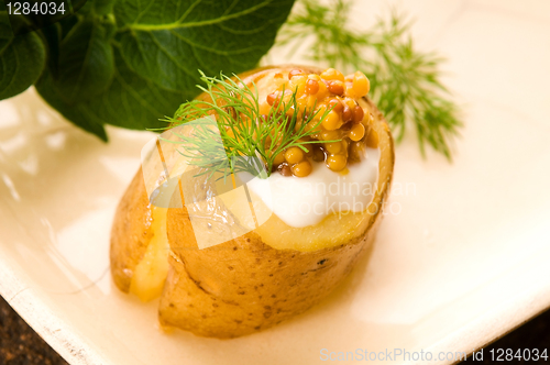 Image of Baked potato with sour cream, grain Dijon mustard and herbs