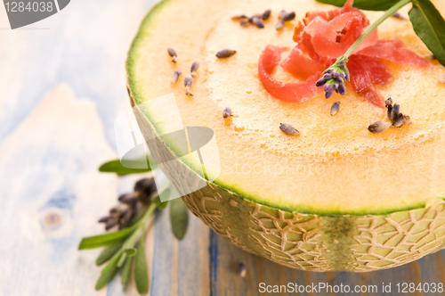 Image of fresh melon soup with parma ham and lavender flower