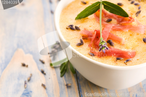 Image of fresh melon soup with parma ham and lavender flower