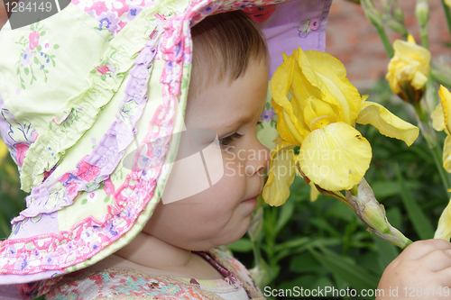 Image of Little girl with yellow flower