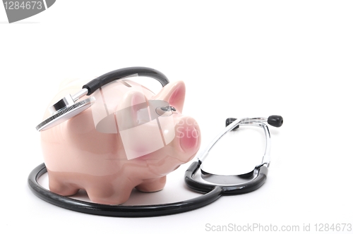 Image of stethoscope and piggy bank