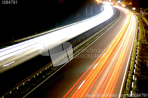 Image of road with car traffic at night with blurry lights