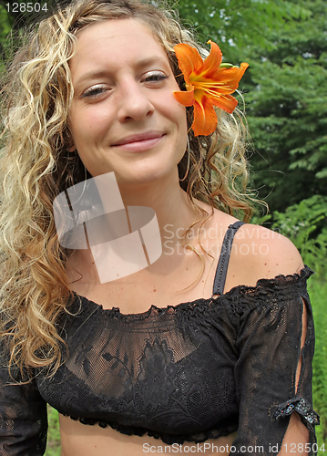 Image of Orange flower in her ear