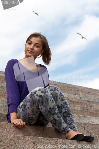 Image of girl sitting on the marble stairs 