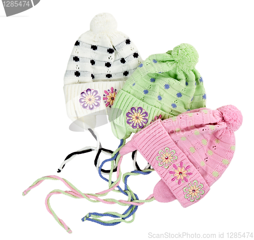 Image of three colored children's knitted hat with a flower pattern