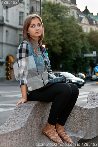 Image of girl sitting on a street