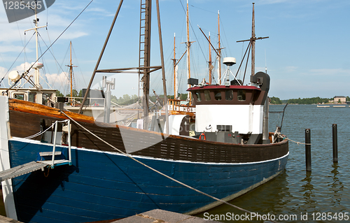 Image of Wooden blue boat in the port