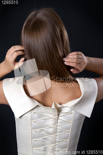 Image of Beautiful slim girl in a wedding dress with a corset back
