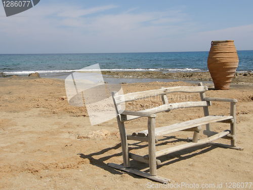 Image of A pot and a bench on the seashore