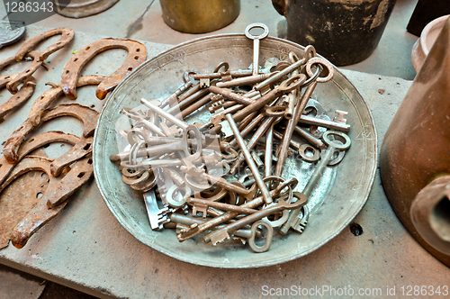 Image of a lot of old brass key on an old plate