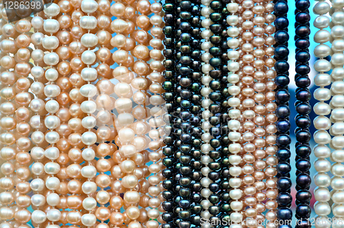 Image of a lot of pearl beads hanging in a row