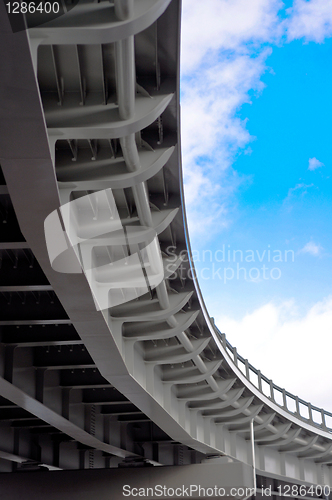 Image of automobile overpass on background of blue sky with clouds. botto